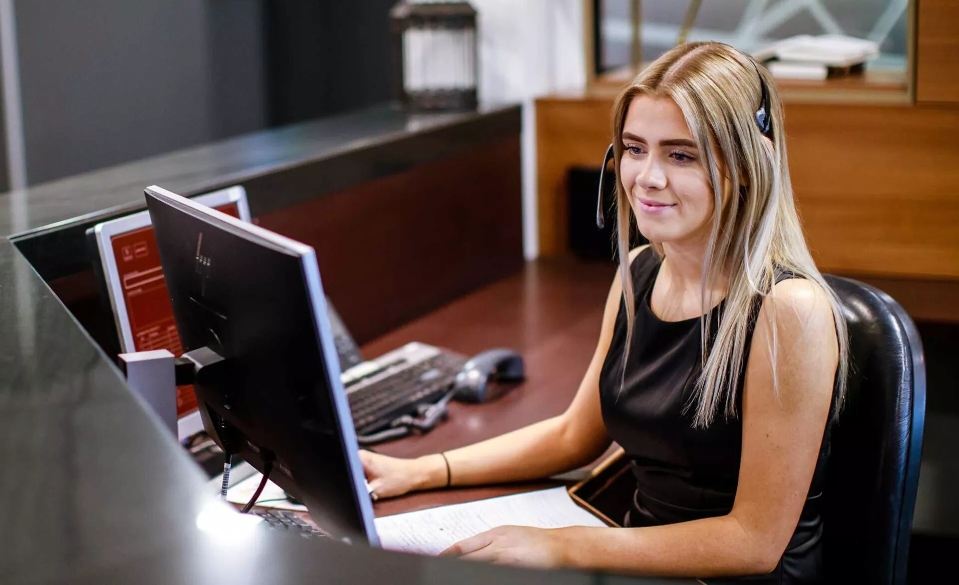Receptionist helping clients at the front desk